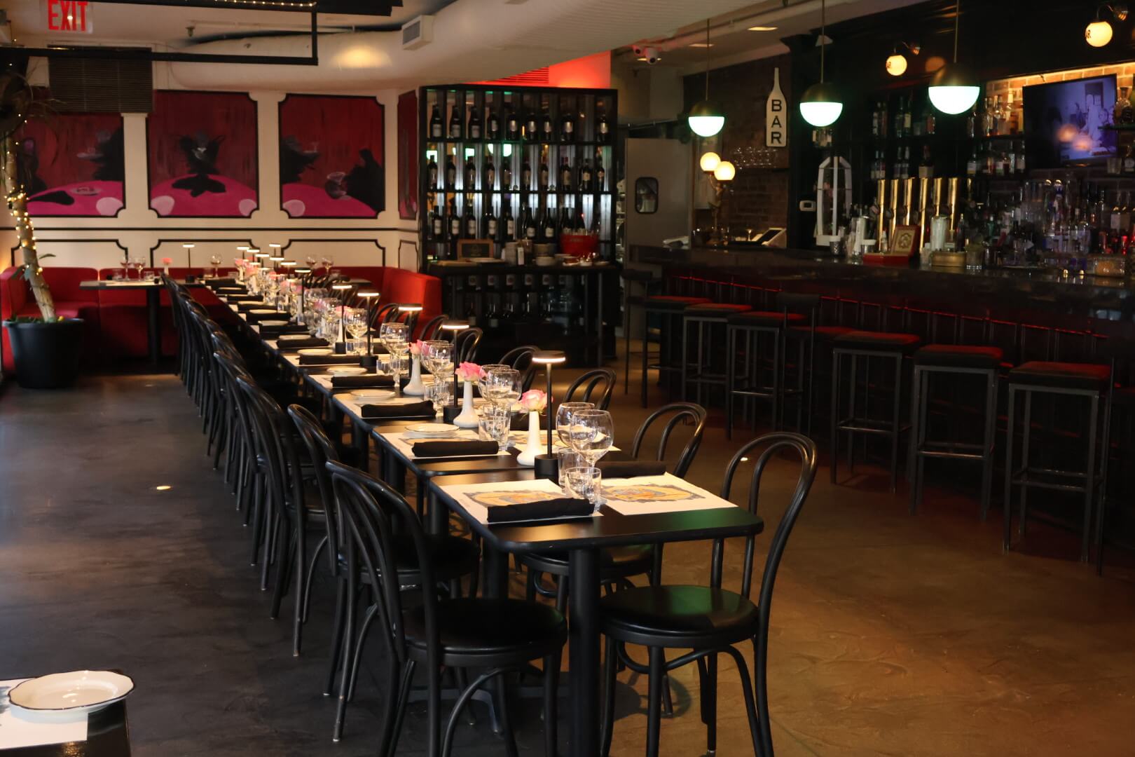 Long table set in middle of the restaurant with bar in background