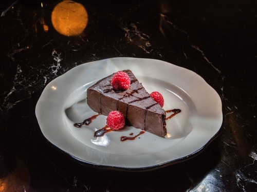 A piece of chocolate cake with raspberries