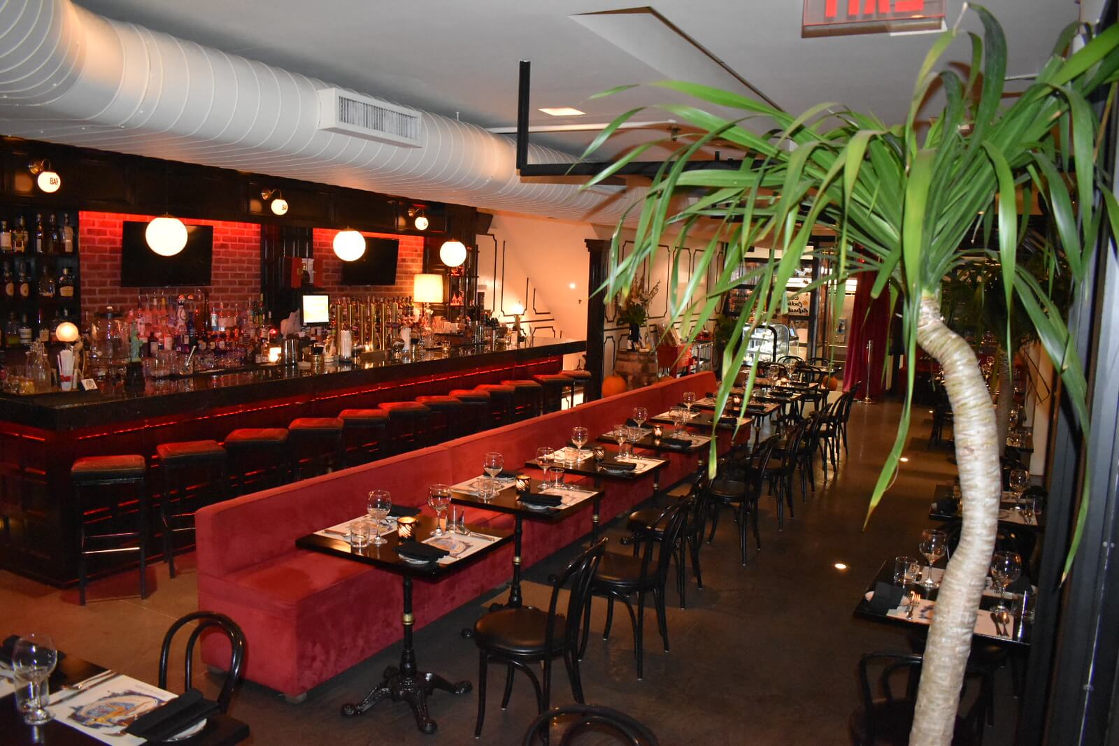 Restaurant interior showing booths and bar at night