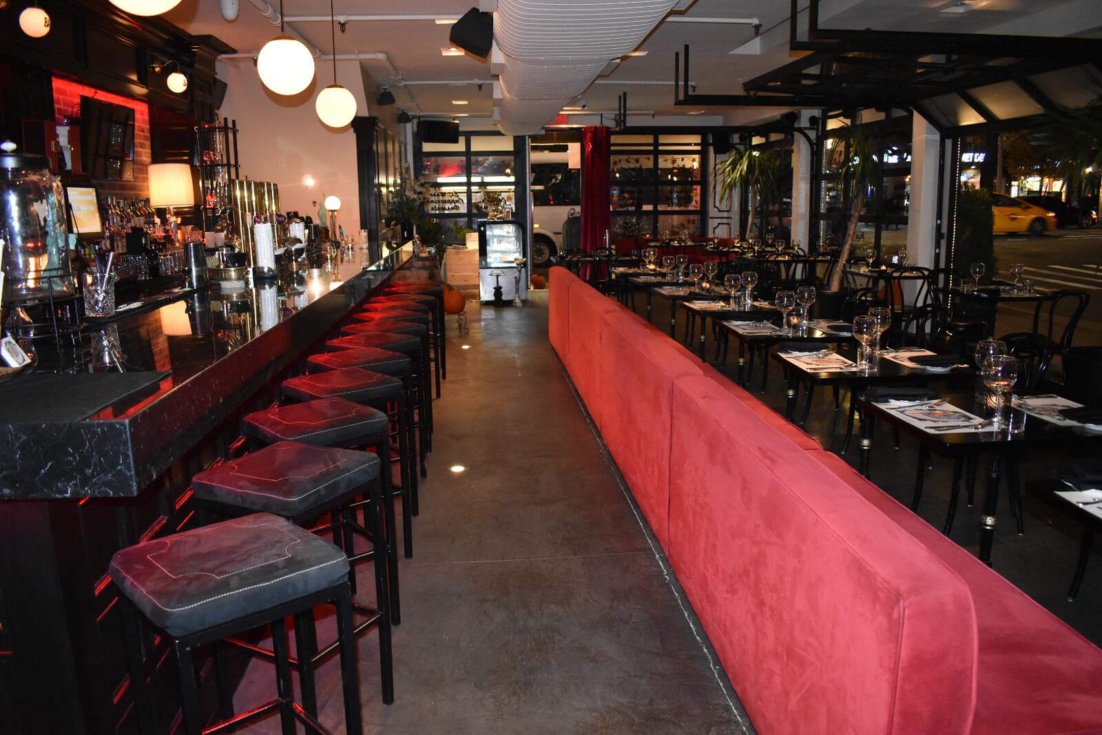 Restaurant interior showing back of booths and bar at night