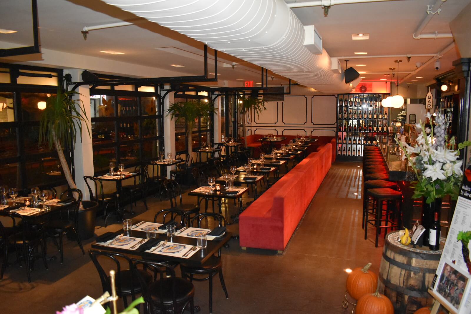 Restaurant interior showing the booths, tables, and windows at night