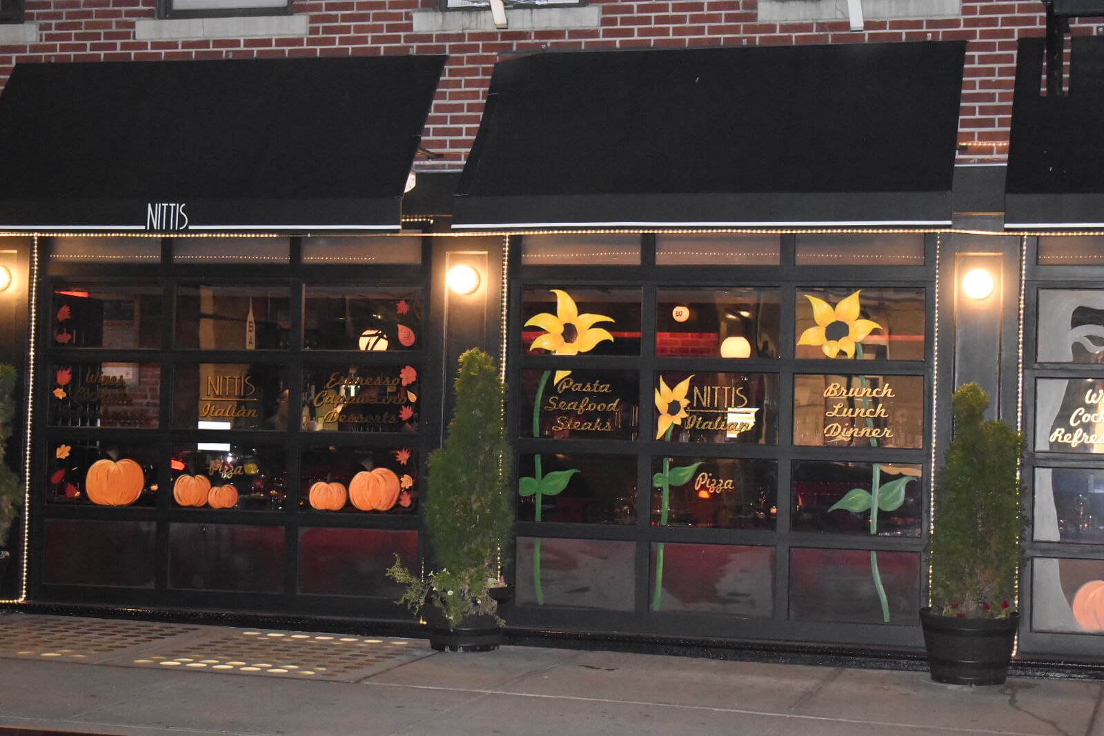 Street view of the restaurant with pumpkins and flowers painted on the windows